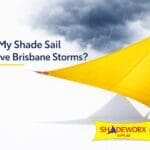 yellow shade sail installation resisting Brisbane storm winds with ShadeWorx logo